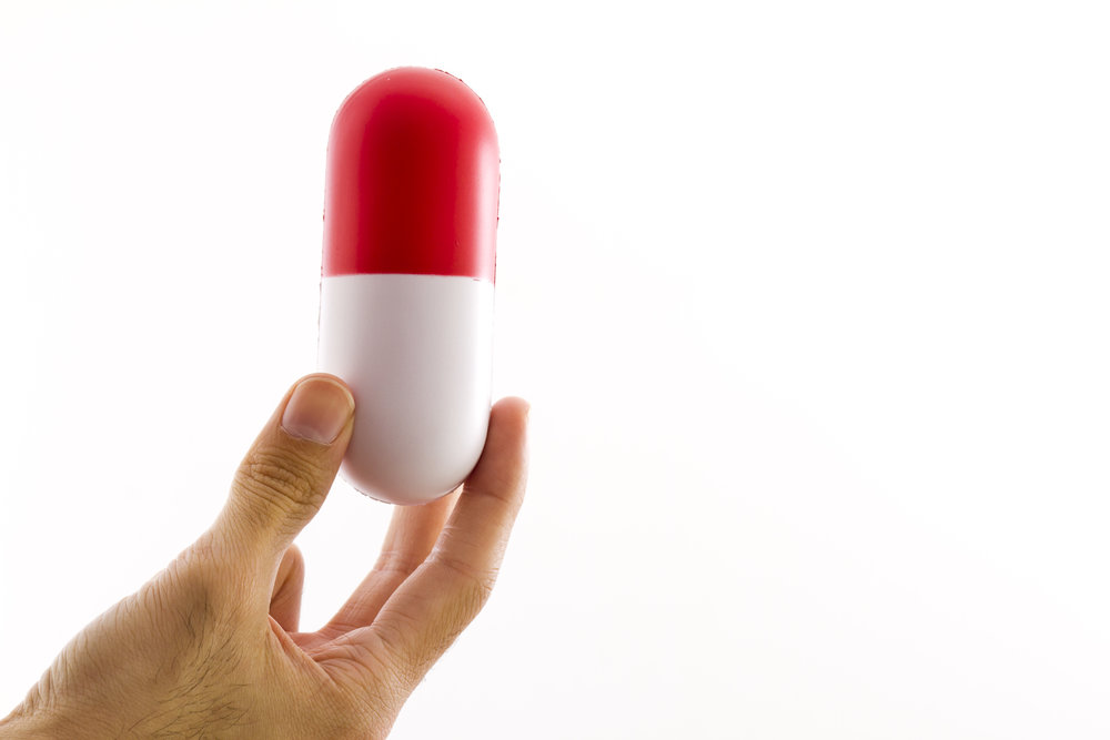 person holding large pill