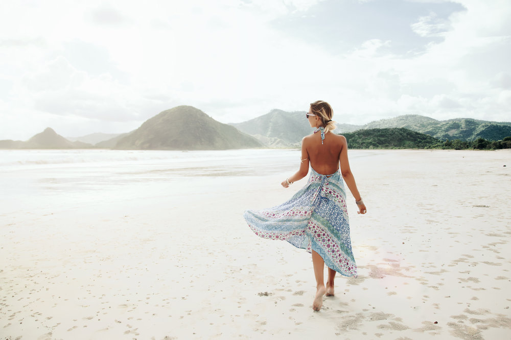 a woman walking on a beach