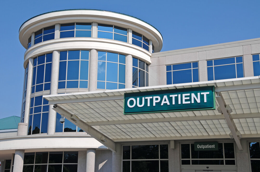 a hospital exterior with "outpatient" sign