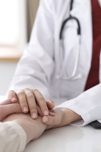 doctor holding patients hands
