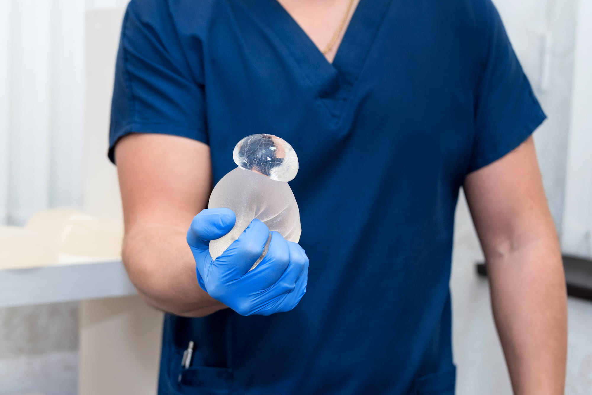 surgeon holding breast implant