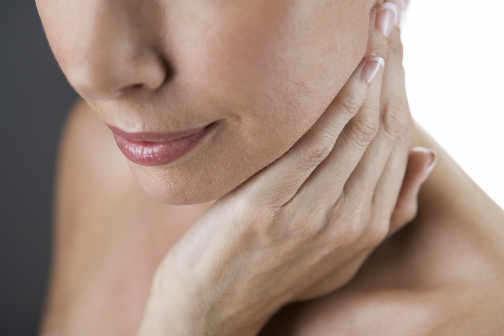 Profile of a woman with her hand on her neck