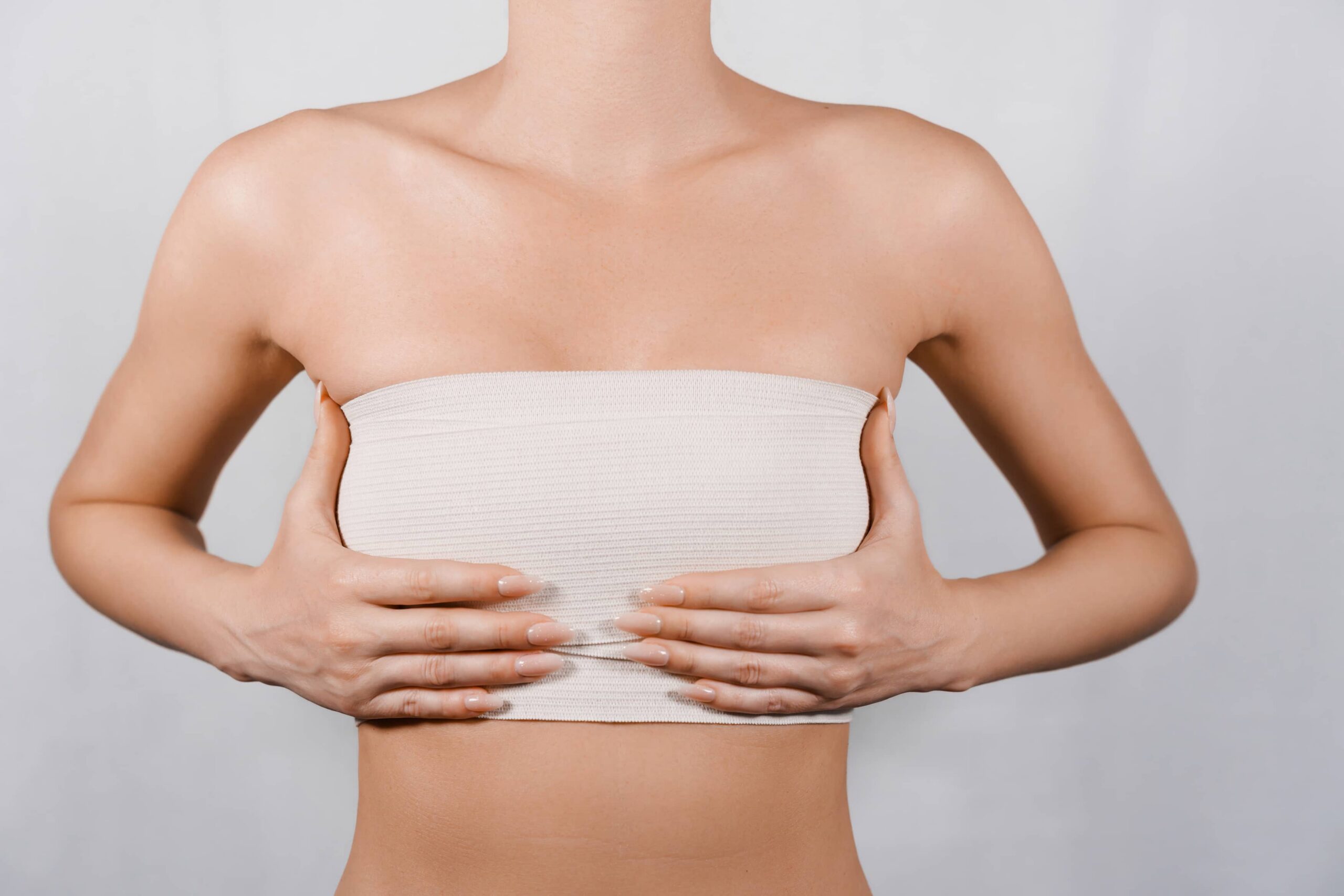 Woman with hands up to breasts